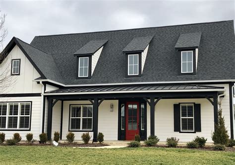 white brick house with metal roof|black shingles on brick house.